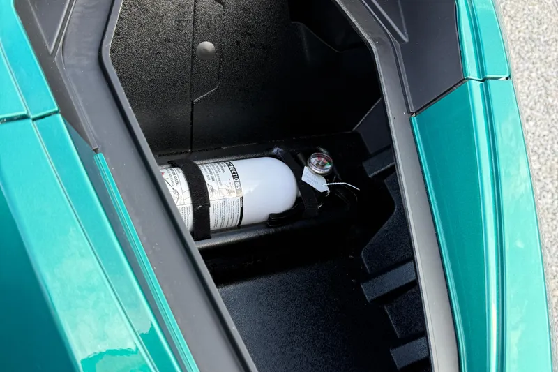 Slide: The Image of 2024 Taiga Orca storage compartment with fire extinguisher, teal exterior. - 11