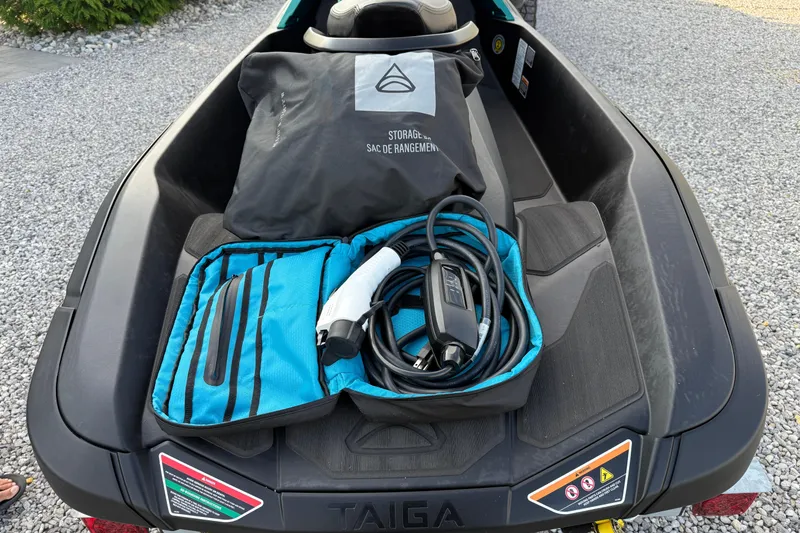 Slide: The Image of 2024 Taiga Orca with storage bag and charging cable on rear deck. - 12