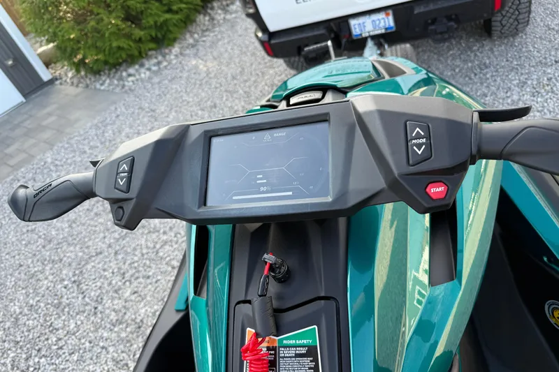 Slide: The Image of 2024 Taiga Orca dashboard with digital display and control buttons, parked on gravel. - 9