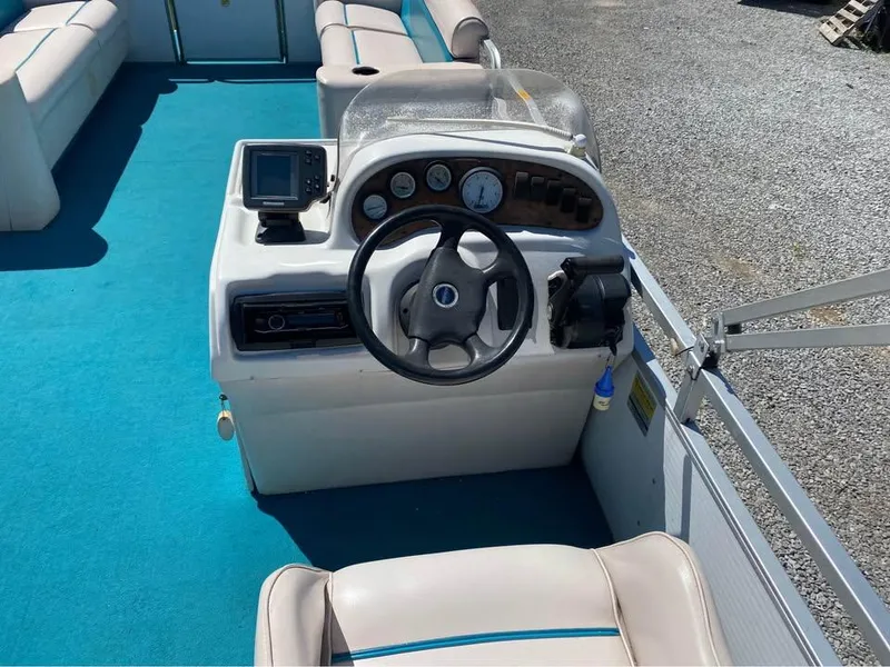 Slide: The Image of 2023 Parti Kraft 240 SC boat interior with steering console and blue carpet. - 6