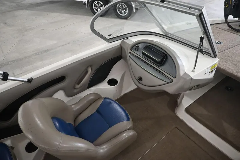 Slide: The Image of 2007 Ranger 180 Reata boat interior with blue and beige seating and dashboard. - 11