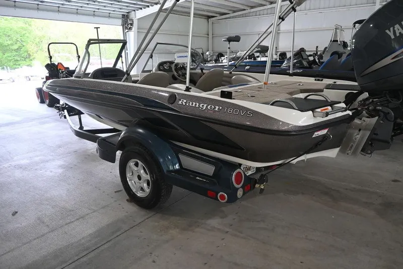Slide: The Image of 2007 Ranger 180 Reata boat in a garage, showcasing sleek design and trailer. - 2