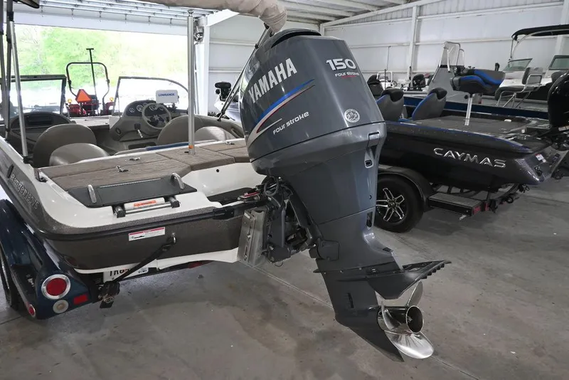 Slide: The Image of 2007 Ranger 180 Reata boat with Yamaha 150 outboard motor in a garage setting. - 3