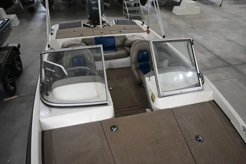 Slide: The Image of 2007 Ranger 180 Reata boat with open cockpit and seating, displayed indoors. - 7