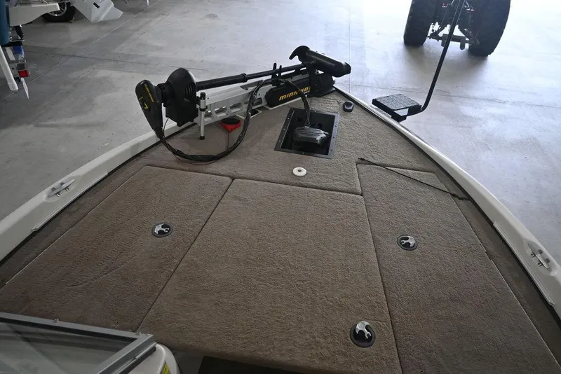 Slide: The Image of 2007 Ranger 180 Reata boat deck with trolling motor in a garage setting. - 9