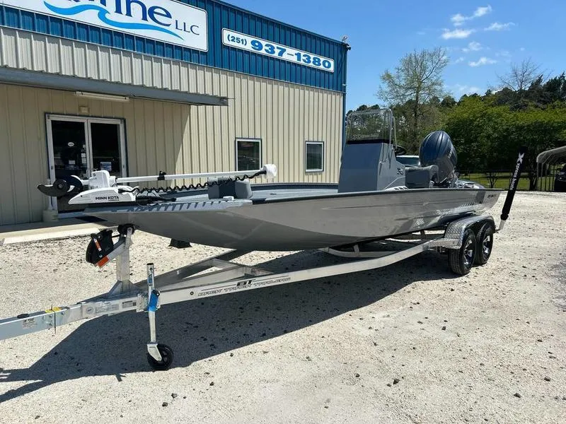 Slide: The Image of 2025 Xpress H210B boat on trailer outside a building under a clear blue sky. - 1