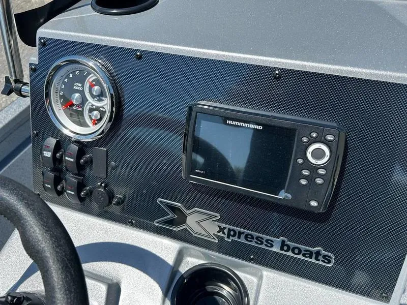 Slide: The Image of Dashboard of 2025 Xpress H210B boat with gauges and Humminbird display. - 12