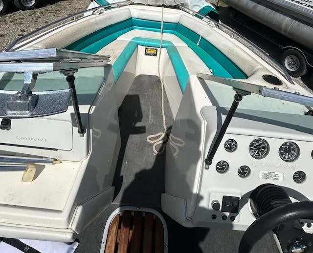 Slide: The Image of 1992 Caravelle 2000 boat interior with teal and white seating, dashboard, and steering wheel. - 6