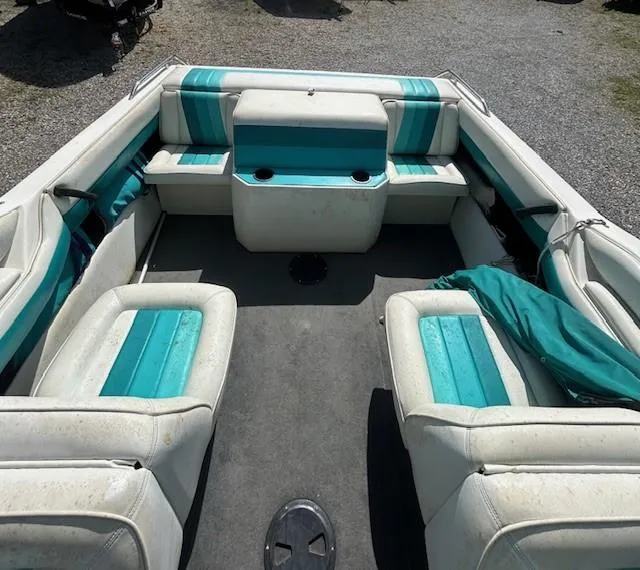 Slide: The Image of Interior of a 1992 Caravelle 2000 boat with teal and white seating. - 8