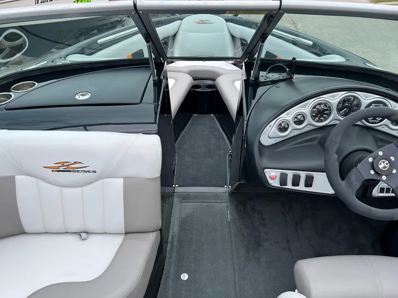 Slide: The Image of 2006 MasterCraft X1 boat interior with steering wheel and dashboard controls. - 12