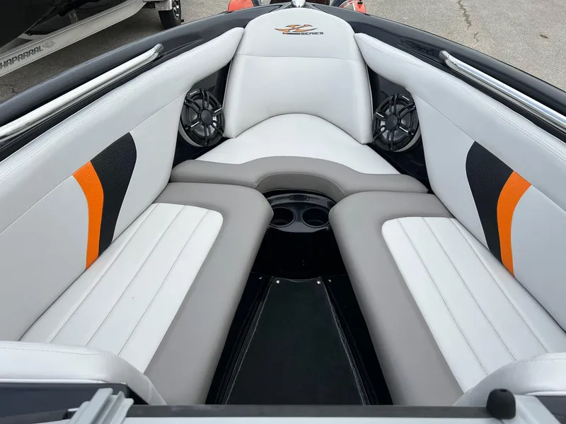 Slide: The Image of 2006 MasterCraft X1 boat interior with white and gray seating, orange accents, and cup holders. - 17