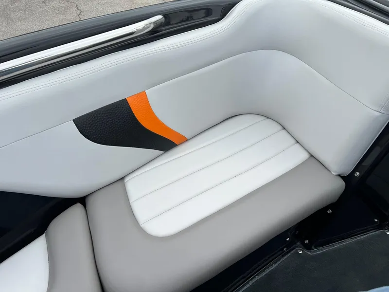 Slide: The Image of 2006 MasterCraft X1 boat interior with white, gray, and orange upholstery. - 18