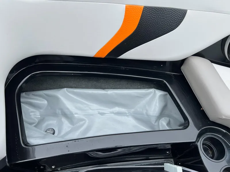 Slide: The Image of 2006 MasterCraft X1 boat interior storage compartment with orange and black accents. - 21