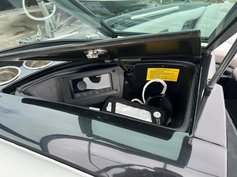 Slide: The Image of Open storage compartment in 2006 MasterCraft X1 boat dashboard. - 24