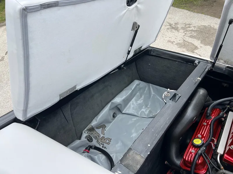 Slide: The Image of 2006 MasterCraft X1 boat storage compartment with ballast bag and engine components. - 27