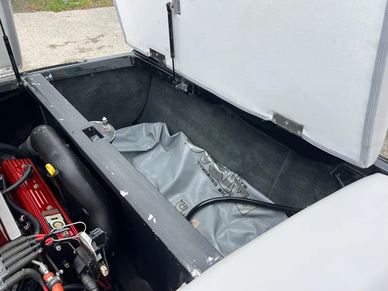Slide: The Image of Open engine compartment of a 2006 MasterCraft X1 boat, showing internal components. - 28