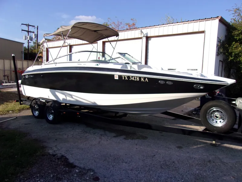 Slide: The Image of 2004 Cobalt 240SD boat on trailer, black and white design, parked outdoors. - 1