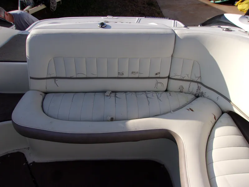 Slide: The Image of 2004 Cobalt 240SD boat interior with worn white leather seating. - 10