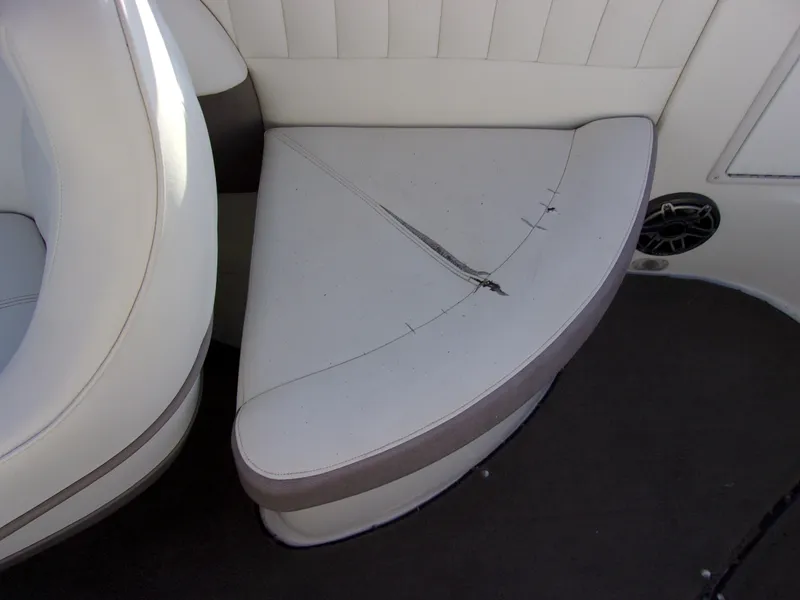Slide: The Image of 2004 Cobalt 240SD boat seat with visible tear and wear. - 12