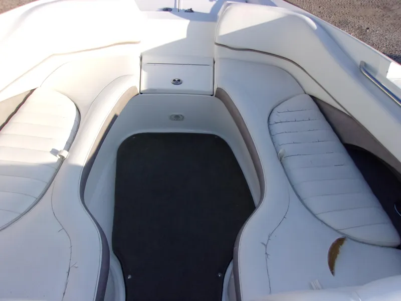 Slide: The Image of 2004 Cobalt 240SD boat interior with white seating and storage compartment. - 14