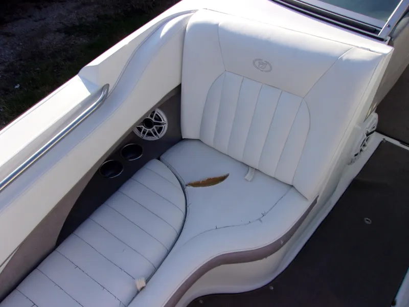 Slide: The Image of 2004 Cobalt 240SD boat interior with white leather seating and cup holders. - 15