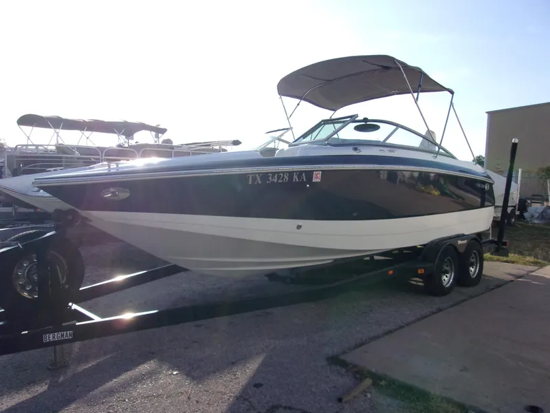 Slide: The Image of 2004 Cobalt 240SD boat on trailer with canopy, parked outdoors. - 2