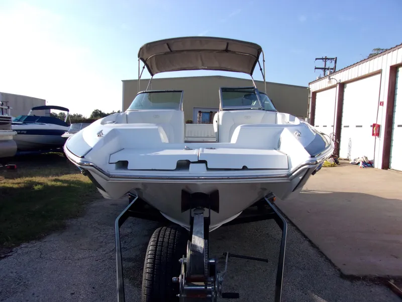 Slide: The Image of 2004 Cobalt 240SD boat on trailer, parked outdoors near storage buildings. - 3