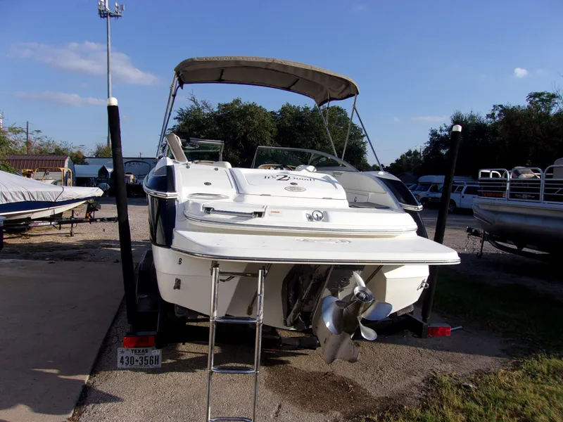 Slide: The Image of 2004 Cobalt 240SD boat with canopy, parked on trailer in outdoor storage area. - 4