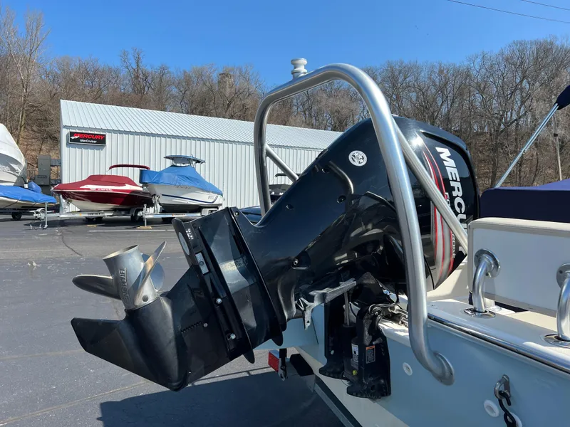 Slide: The Image of 2019 Boston Whaler 170 Montauk with Mercury outboard motor in a boatyard setting. - 2