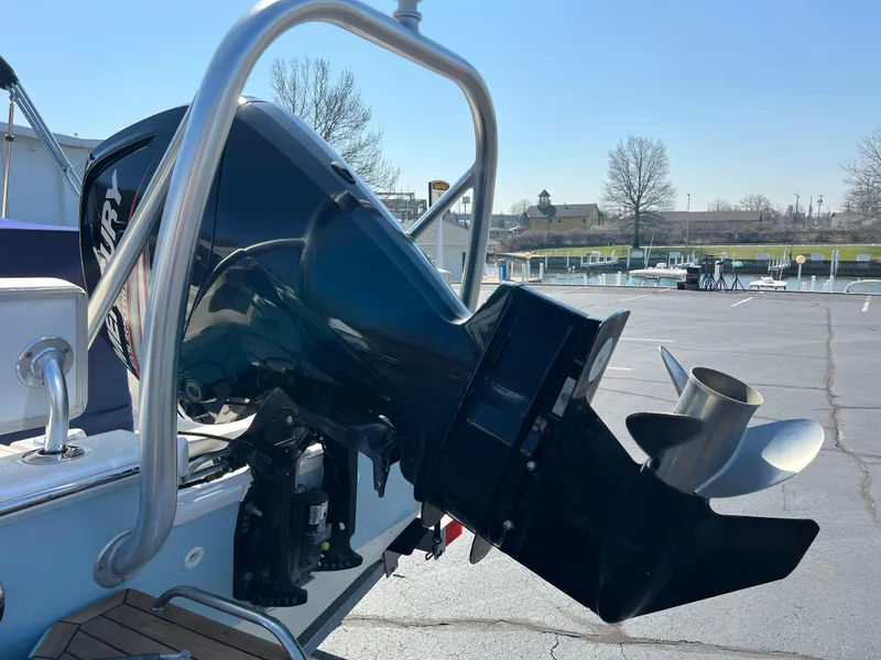 Slide: The Image of 2019 Boston Whaler 170 Montauk boat with outboard motor in a parking lot. - 3