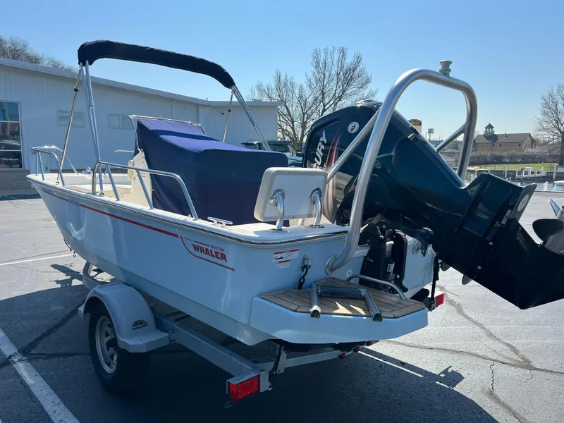 Slide: The Image of 2019 Boston Whaler 170 Montauk boat on trailer, parked outdoors. - 4