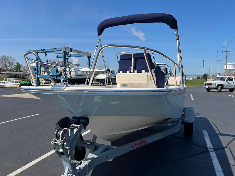 Slide: The Image of 2019 Boston Whaler 170 Montauk boat on trailer, parked in a marina lot. - 5