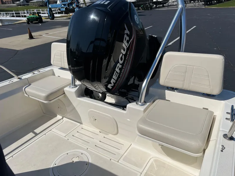 Slide: The Image of 2019 Boston Whaler 170 Montauk boat with Mercury engine, featuring beige seating. - 7