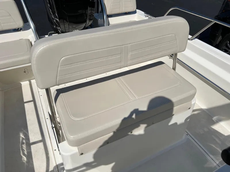 Slide: The Image of 2019 Boston Whaler 170 Montauk boat seat, beige upholstery, sunlight casting shadows. - 8