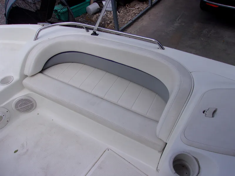 Slide: The Image of 2004 VIP Deckliner 191 boat seating area with white cushioned bench and speaker. - 11