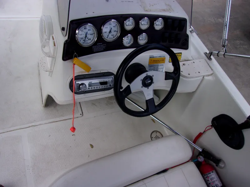 Slide: The Image of 2004 VIP Deckliner 191 boat dashboard with steering wheel and gauges. - 6