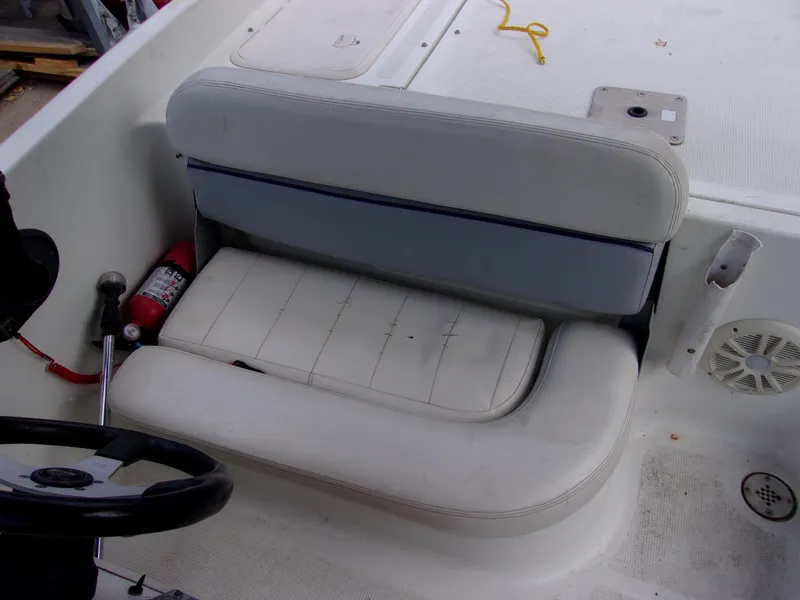 Slide: The Image of 2004 VIP Deckliner 191 boat interior with white seating and steering wheel. - 7