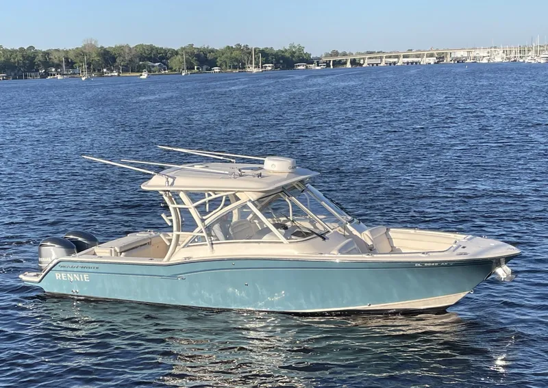 The Image of 2019 Grady-White Freedom 325 boat on calm water, clear sky background. - 0