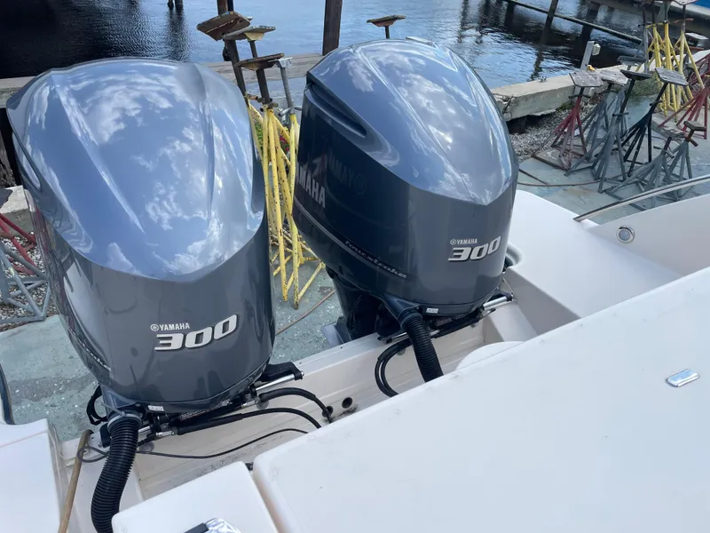 Slide: The Image of Twin Yamaha 300 engines on a 2019 Grady-White Freedom 325 boat by the water. - 10