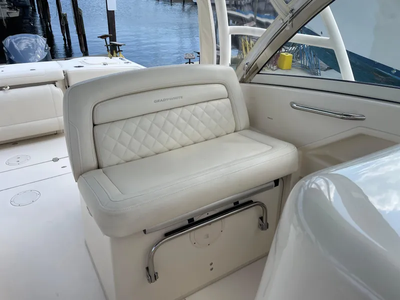 Slide: The Image of 2019 Grady-White Freedom 325 boat interior with white cushioned seating. - 15