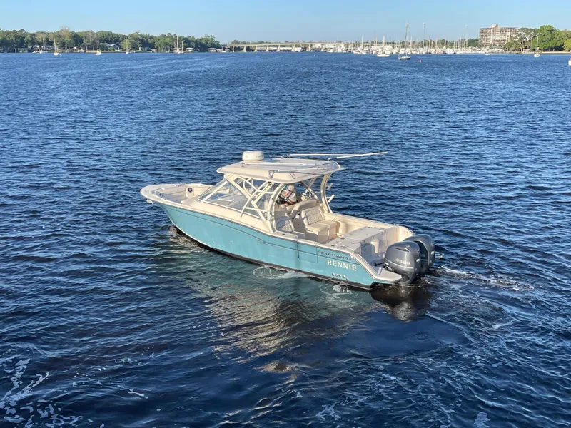 Slide: The Image of 2019 Grady-White Freedom 325 boat cruising on a calm blue lake. - 2