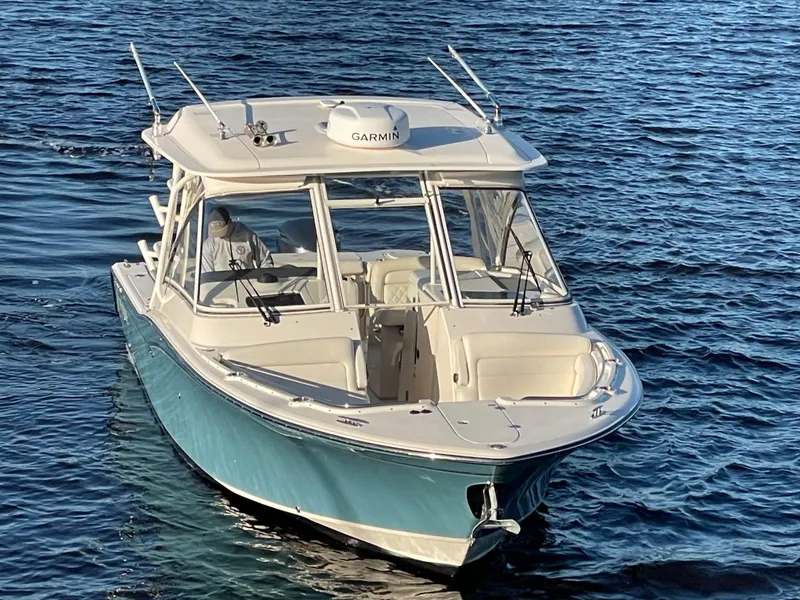 Slide: The Image of 2019 Grady-White Freedom 325 boat on water, featuring Garmin equipment. - 5