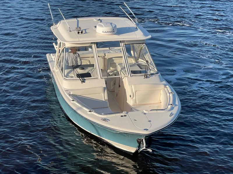 Slide: The Image of 2019 Grady-White Freedom 325 boat cruising on open water. - 6