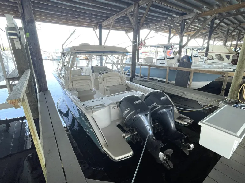 Slide: The Image of 2019 Grady-White Freedom 325 boat docked with twin Yamaha outboard engines. - 8