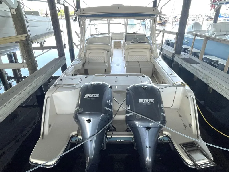 Slide: The Image of 2019 Grady-White Freedom 325 boat with dual 300 horsepower engines docked in marina. - 9