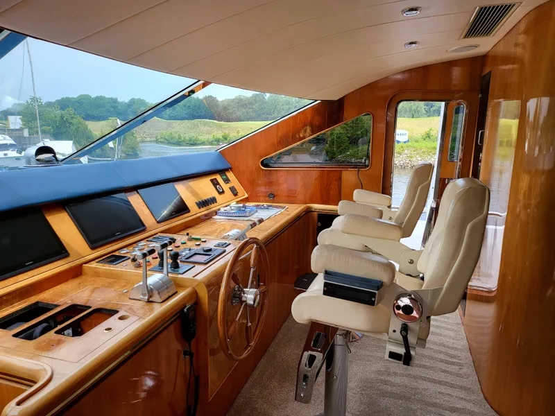 Slide: The Image of Interior of 2000 Horizon 74 Motor Yacht with helm, controls, and captain's chairs. - 12
