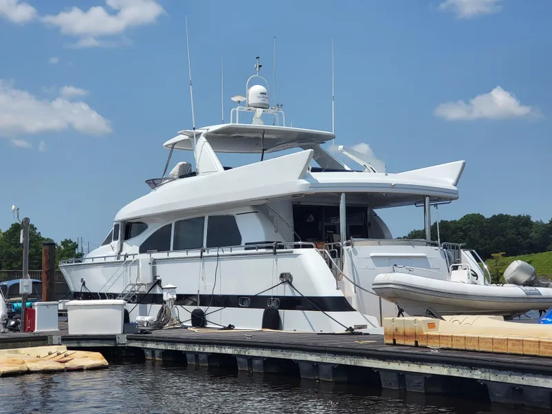 Slide: The Image of Horizon 74 Motor Yacht 2000 docked under a clear blue sky. - 2