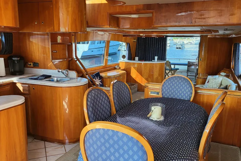 Slide: The Image of Luxurious interior of a 2000 Horizon 74 Motor Yacht with elegant wood finishes and dining area. - 20