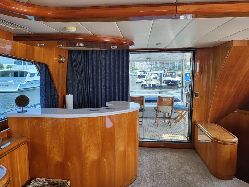 Slide: The Image of Luxurious interior of 2000 Horizon 74 Motor Yacht with elegant wood finishes and marina view. - 21