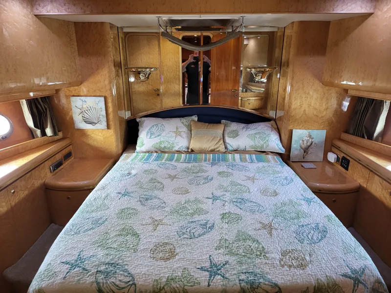Slide: The Image of Luxurious bedroom in 2000 Horizon 74 Motor Yacht with nautical-themed bedding. - 23